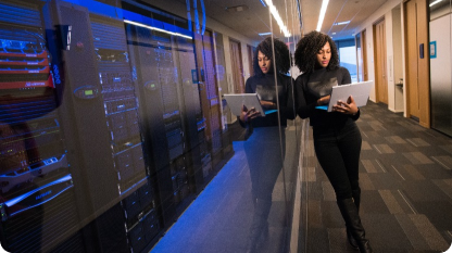 person in server room on computer