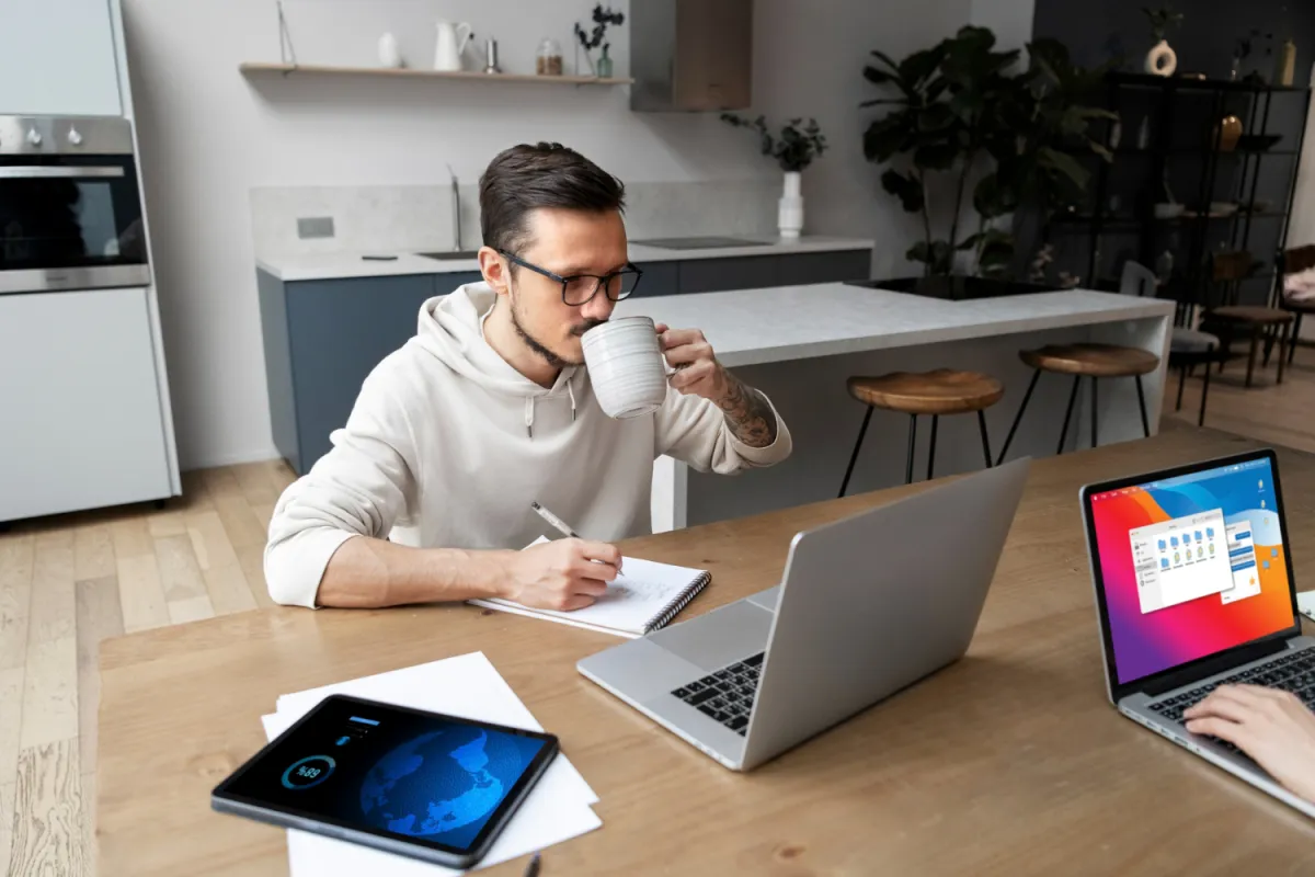 work at home from kitchen table with partner drinking coffee