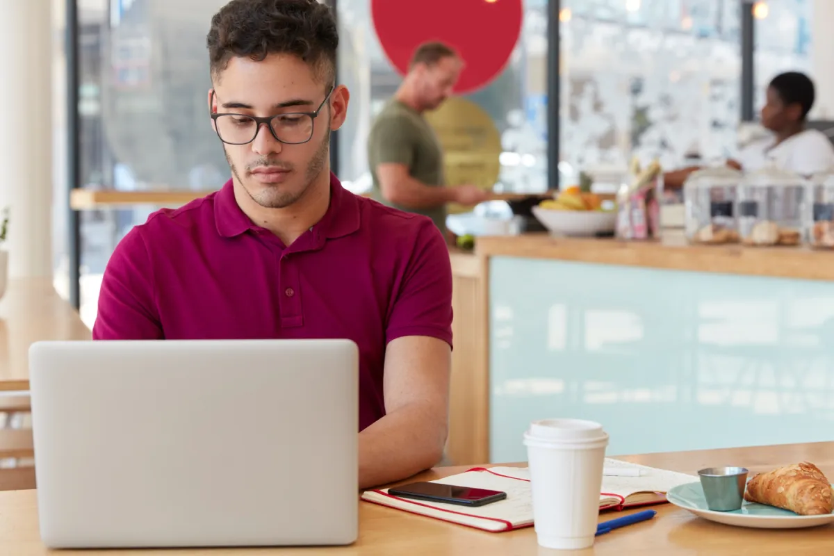 developer working at a cafe on a project remotely