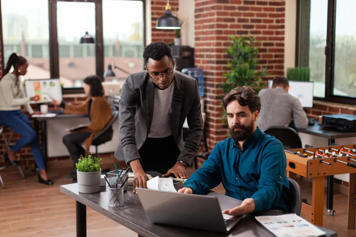 manager and developer working at computer in office